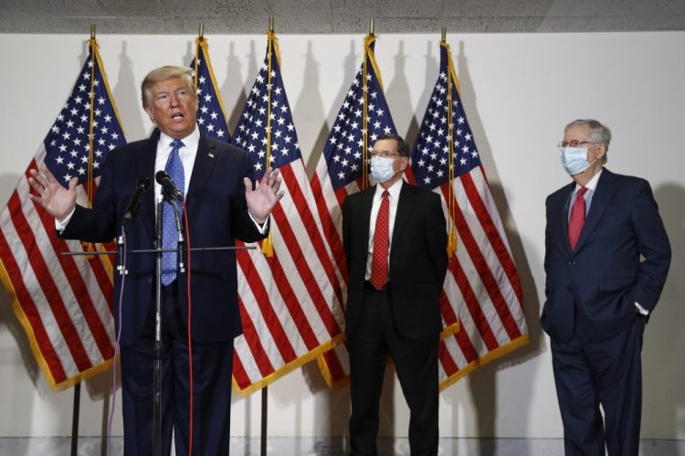 President Trump speaks with reporters May 19 after meeting with Senate Republicans at their weekly luncheon on Capitol Hill in Washington. Standing behind Trump are Sen. John Barrasso, R-Wyo., second from right, and Senate Majority Leader Mitch McConnell of Kentucky.