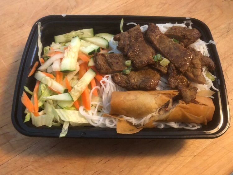 Bun, a rice noodle dish, included roast pork, vegetables and an egg roll, from Taytene Cafe in South Portland. 