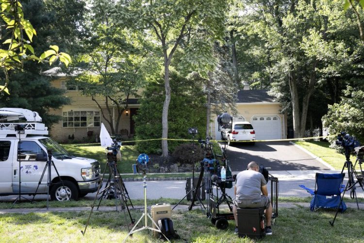 News media is set up in front of the home of U.S. District Judge Esther Salas in North Brunswick, N.J. A gunman posing as a delivery person shot and killed Salas' 20-year-old son and wounded her husband Sunday evening at their home before fleeing, according to judiciary officials.  