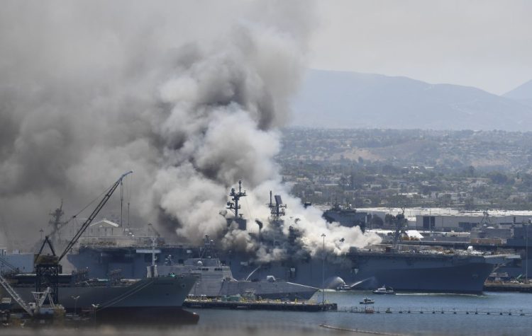 Smoke rises from the USS Bonhomme Richard at Naval Base San Diego Sunday after an explosion and fire onboard. (AP Photo/Denis Poroy)