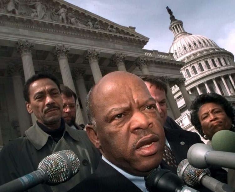 U.S. Rep. John Lewis, D-Ga., speaks with reporters March 5, 1999, in Washington. Lewis, who carried the struggle against racial discrimination from Southern battlegrounds of the 1960s to the halls of Congress, died Friday.