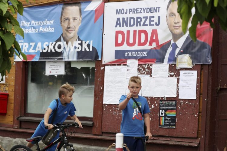 Campaign posters of incumbent conservative President Andrzej Duda and his challenger, the liberal Warsaw Mayor Rafal Trzaskowski, are seen in Raciaz, Poland. 