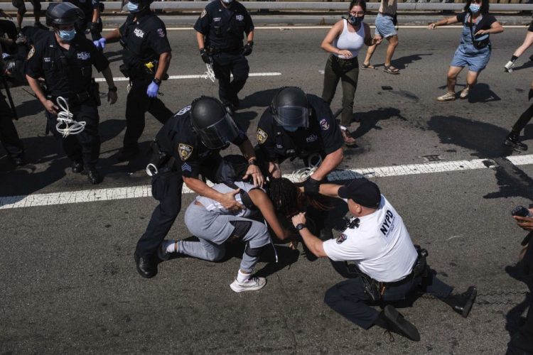 Black Lives Matter protesters are arrested by New York police officers on the Brooklyn Bridge on July 15.