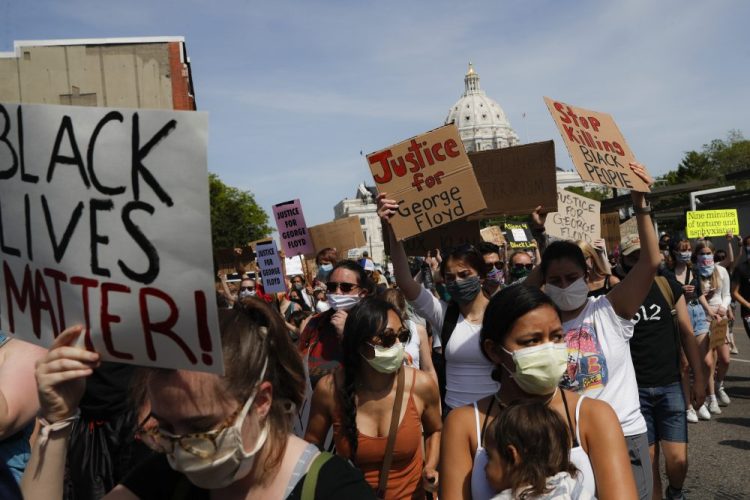 Protesters march away from the State Capitol on May 31 in St. Paul, Minn.