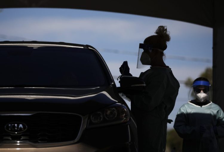 Healthcare workers test patients in their cars at a drive-thru coronavirus testing site in Las Vegas earlier this month. Three Russian websites have leveraged the pandemic to promote anti-Western objectives and to spread disinformation.