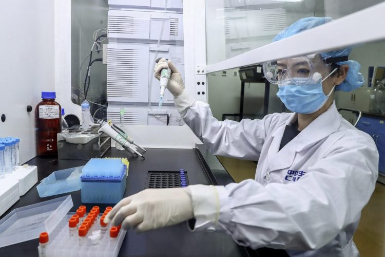 A staff member tests samples of a potential COVID-19 vaccine at a production plant of SinoPharm in Beijing in April. 