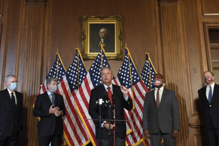 Sen. Lindsey Graham, R-S.C., center, speaks during a news conference on on Capitol Hill in Washington on Monday to highlight the Republican proposal for the next coronavirus stimulus bill. Joining Graham, from left, is Senate Majority Leader Mitch McConnell of Ky., Sen. Roy Blunt, R-Mo., Sent. Tim Scott, R-S.C., and Sen. Richard Shelby, R-Ala. 