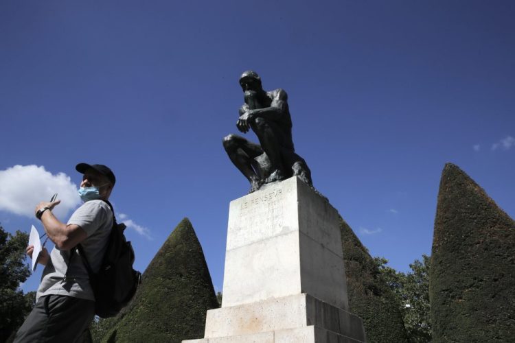 A visitor walks past "Le Penseur" (The Thinker) by French sculptor Auguste Rodin in Paris. The Musee Rodin can sell 12 bronze replica editions to help offset the cost of the pandemic. 