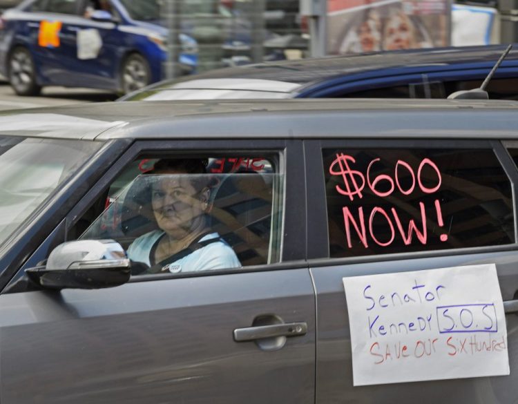Motorists take part in a caravan protest asking for the extension of the $600 in unemployment benefits to people out of work because of the coronavirus Wednesday in front of Senator John Kennedy's office at the Hale Boggs Federal Building in New Orleans, La.