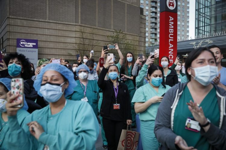 Medical personnel attend a daily 7 p.m. applause in their hono April 28 during the coronavirus pandemic outside NYU Langone Medical Center in the Manhattan borough of New York.