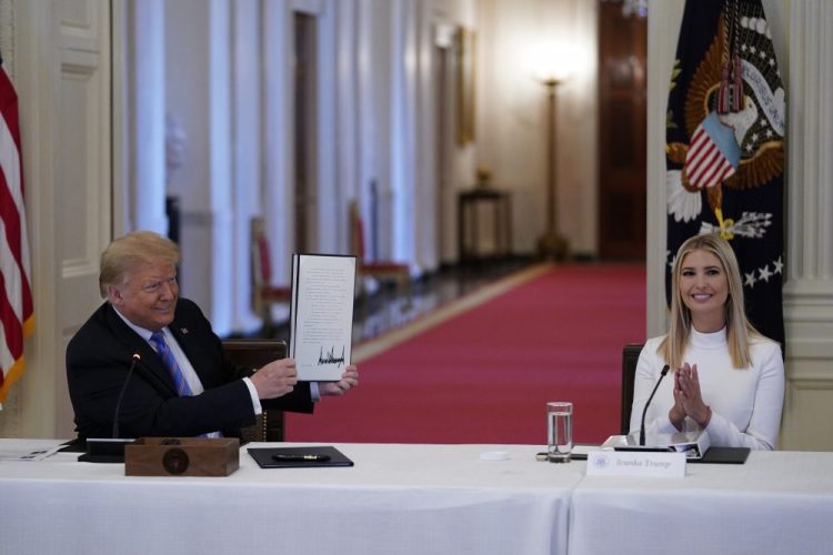 Ivanka Trump applauds as President Trump holds an executive order that he signed during a meeting with the American Workforce Policy Advisory Board on June 26. A new White House-backed ad campaign aims to encourage people who are unemployed or unhappy in their jobs or careers to “find something new" despite the increasing rise in unemployment due to the pandemic.