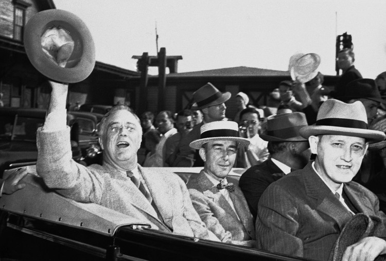 President Franklin D. Roosevelt acknowledges the cheers of the crowd that greeted him at Rockland on Aug. 28, 1941, on his way to the train station to go to Washington. The President had disembarked from the yacht Potomac which had carried him to his historic meeting with Winston Churchill. 