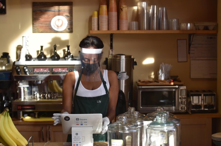 Lily Damtew, owner of Abyssinia Market and Coffee House reopened her small business in Alexandria, Va., on Saturday. Damtew was assaulted by a maskless man who spat at her feet and hurled chicken and rice at her window when she asked him to cover his face before entering her shop. 