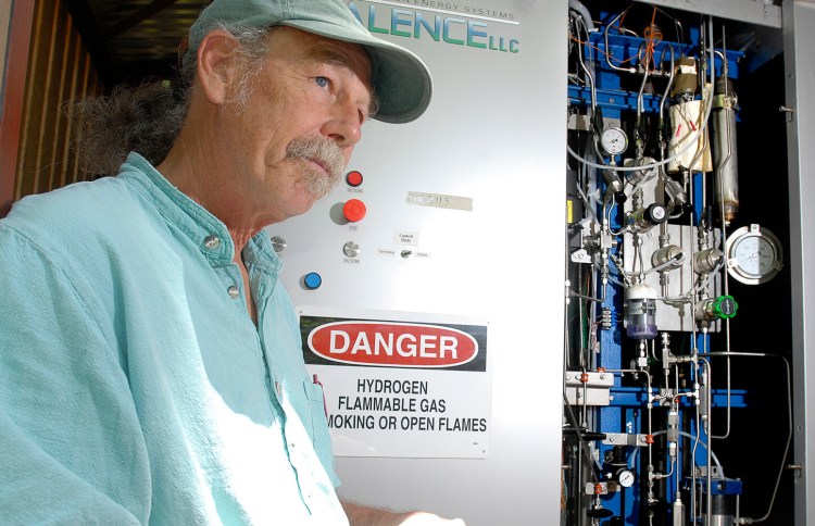 Peter Arnold, project director of Chewonki's  Renewable Hydrogen Project, stands beside the  hydrogen powered back-up electrical system in 2008.