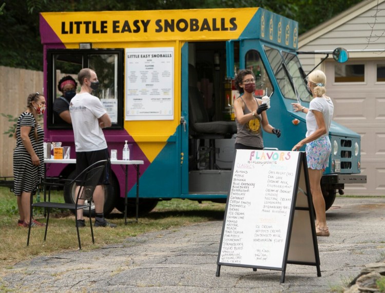 Cassie Pruyn, right, serves a Snoball to a customer during a pop-up event at her home in Portland in early August. This style of shaved ice comes from Louisiana.  