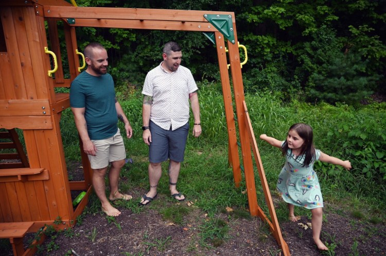 Michael DeFrancisco and his partner Matthew Leavitt watch as their daughter Raenah Defrancisco 6, runs around a swing set outside their Windham home Thursday. Michael and Matthew are looking for other families to join a pandemic pod with theirs for the upcoming school year.