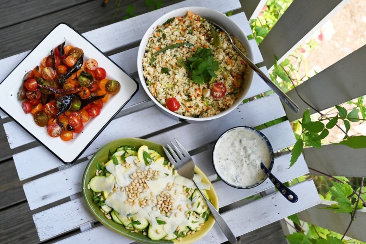 Cooking to beat the heat. Clockwise from top left, Cherry Tomato Salad with Curry Leaves; Everything-But-the-Kitchen-Sink Bulgur Salad; Cucumber Salad with Yogurt, Golden Raisins, Walnuts & Mint; and Shaved Zucchini Salad.