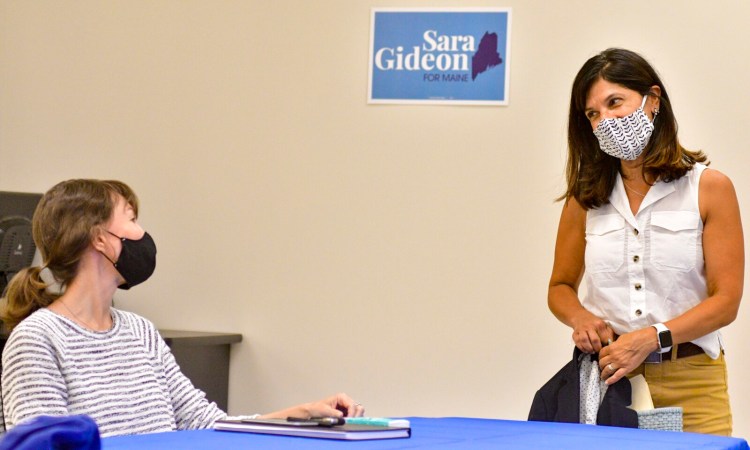 Gretchen Jaeger, left, chats with Senate candidate Sara Gideon before a campaign event Friday in Augusta. During the meeting, Jaeger talked about how slowdowns at the the Postal Service were affecting her business, Halcyon Yarn in Bath.