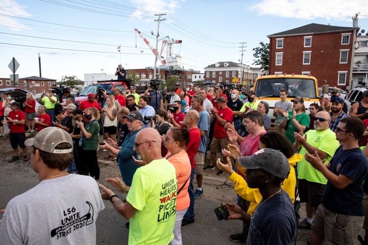 A crowd of Local S6 members cheers as Robert Martinez Jr., the president of the International Machinists and Aerospace Workers, speaks during a rally Saturday outside of the Union Hall across from Bath Iron Works.