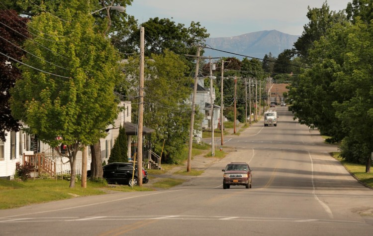 Mount Katahdin provides a backdrop to Katahdin Avenue in Millinocket in this 2017 photo. An inn in Millinocket has been cited by the state for holding an indoor gathering with more than 50 people after a COVID-19 outbreak was traced to a wedding reception held there.