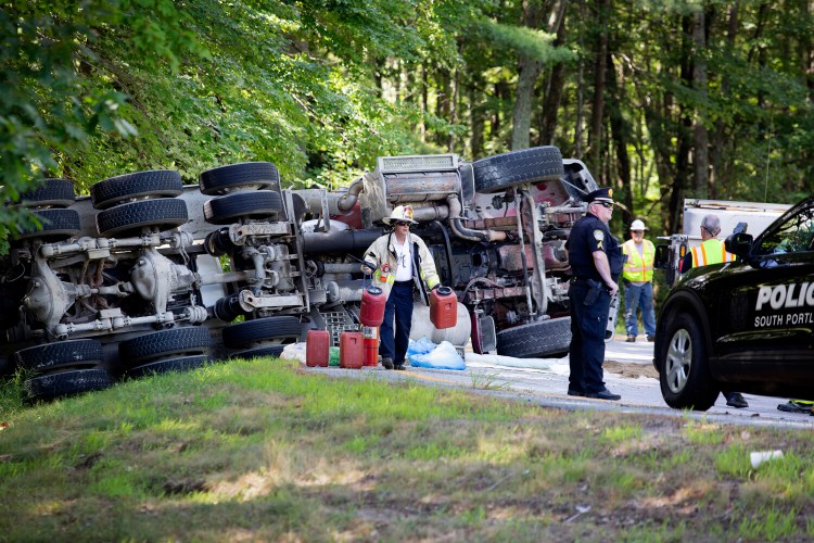 A cement truck rolled over on the South Portland connector to Interstate 295 on Wednesday morning, injuring the driver and spilling diesel fuel. 