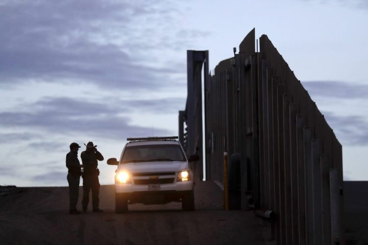 United States Border Patrol agents stand by a vehicle near one of the border walls separating Tijuana, Mexico and San Diego on Nov. 21, 2018. 