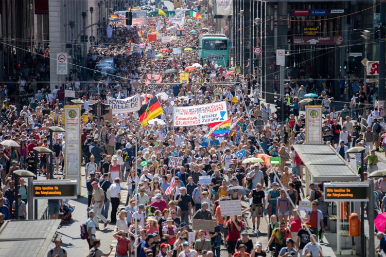Thousands march along the Friedrichstrasse  during a demonstration against virus measures in Berlin, Germany, on Saturday.
