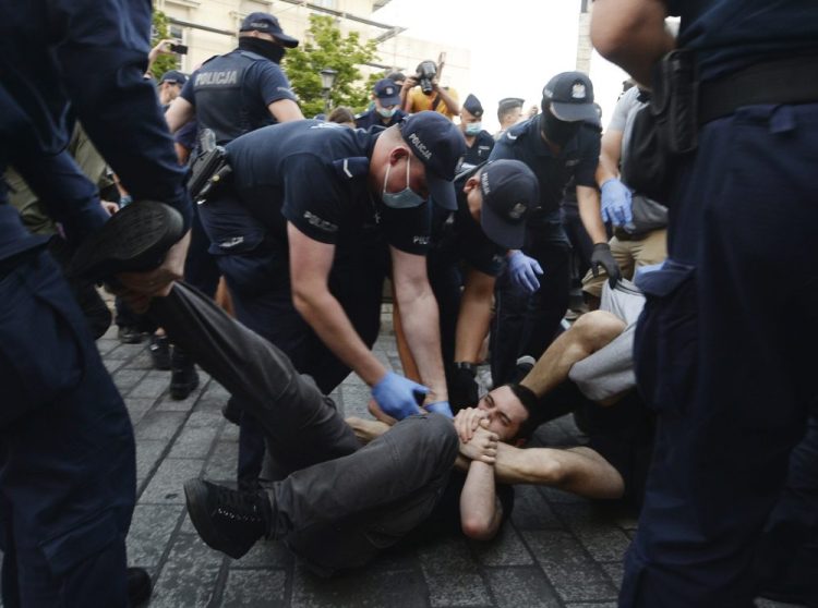 Police scuffle with pro-LGBT protesters angry at the arrest of an LGBT activist in Warsaw, Poland on Friday. 

