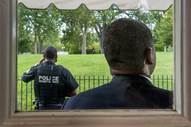 Members of the U.S. Secret Service stand guard outside the James Brady Press Briefing Room as President Trump holds a news conference at the White House on Monday in Washington. Trump briefly left because of a security incident outside the fence of the White House. 
