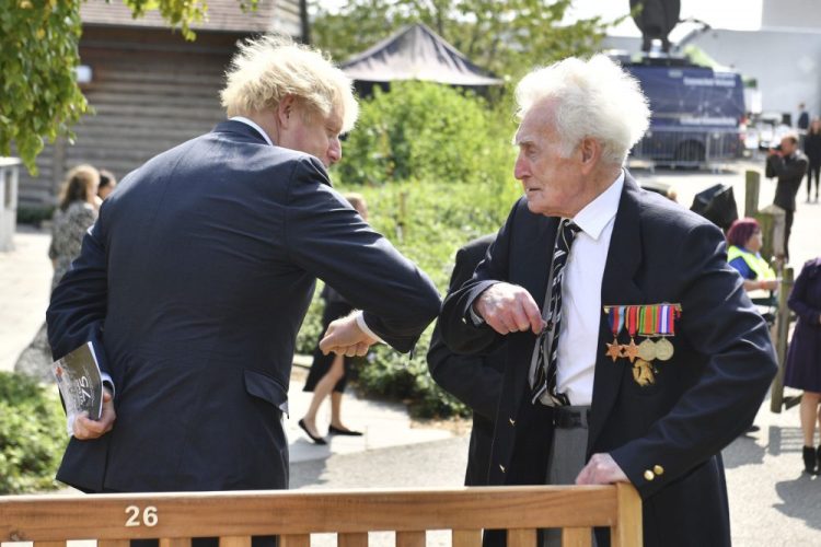 Britain's Prime Minister Boris Johnson greets veteran Bill Redston following the national service of remembrance marking the 75th anniversary of V-J Day at the National Memorial Arboretum in Alrewas, England, on Saturday.
