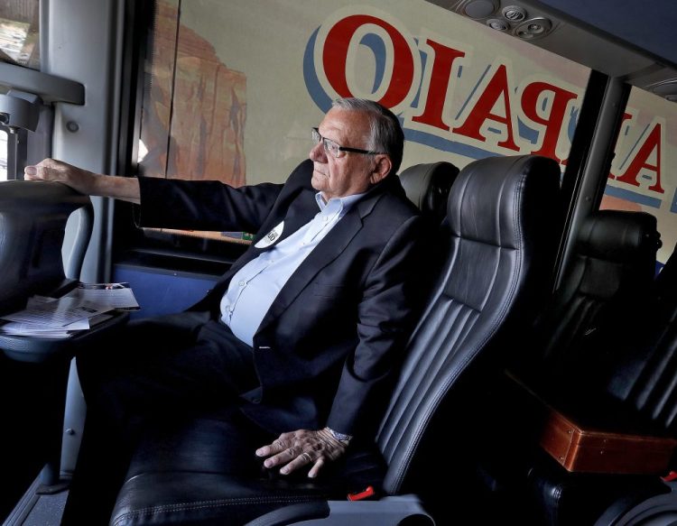 Joe Arpaio rides on his campaign bus in Phoenix in 2018. 

