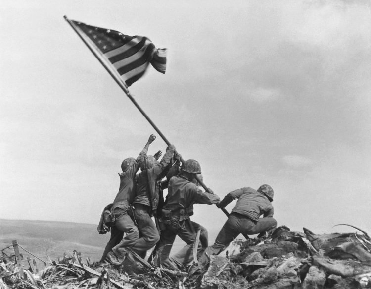 U.S. Marines of the 28th Regiment, 5th Division, raise an American flag atop Mount Suribachi, Iwo Jima, Japan, on Feb. 23, 1945. Strategically located only 660 miles from Tokyo, the Pacific island became the site of one of the bloodiest, most famous battles of World War II against Japan. 

