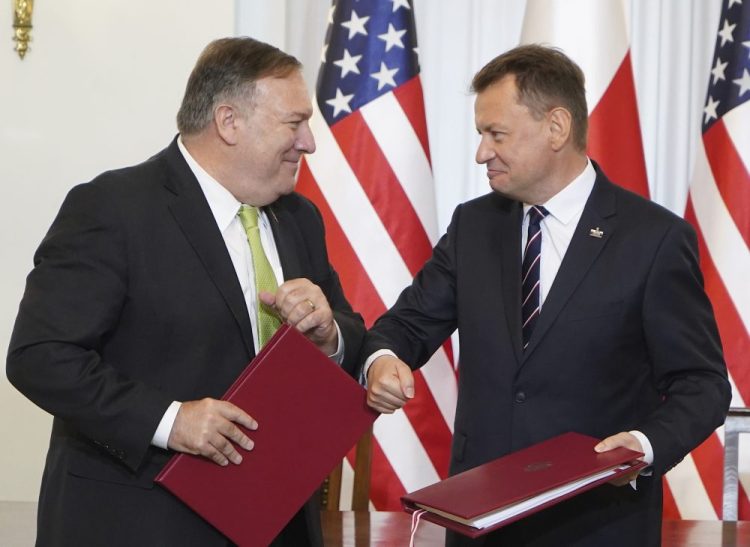 US Secretary of State Mike Pompeo, left, and Poland's Minister of Defence Mariusz Blaszczak greet each other after signing the U.S.-Poland Enhanced Defence Cooperation Agreement in the Presidential Palace in Warsaw on Saturday.  