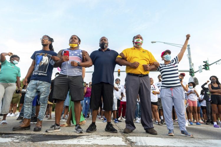 Protesters take to the street and block traffic at the intersection of Willow Street and Evangeline Thruway after a vigil held Saturday, in Lafayette, La., for 31-year-old Trayford Pellerin, who was shot and killed by Lafayette police officers while armed with a knife the night before.