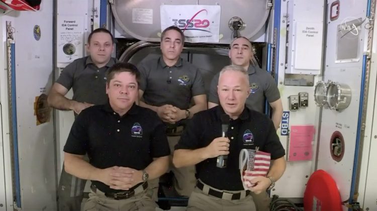 Astronauts Bob Behnken, from left front, and Doug Hurley take part in an interview on the International Space Station on Saturday.

