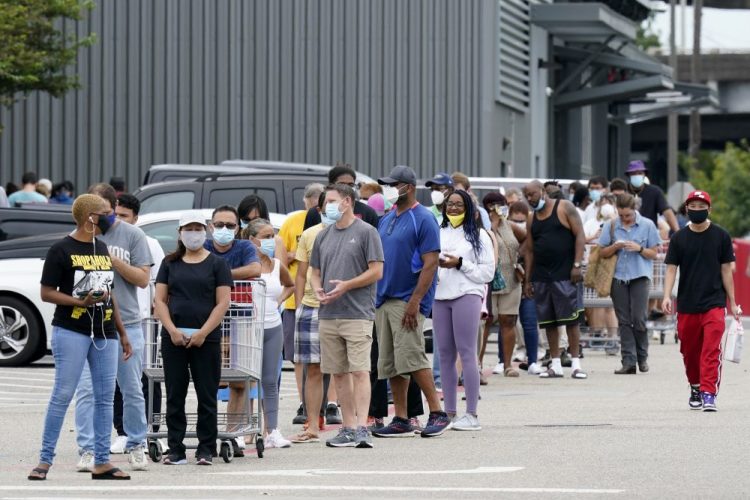 People line up to enter retail chain Costco to buy provisions Sunday in New Orleans, in advance of Hurricane Marco, expected to make landfall on the Southern Louisiana coast.