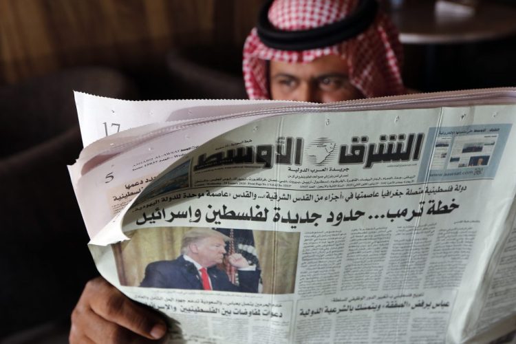 A man holds the daily Asharq Al-Awsat newspaper, fronted by a picture of President Trump, Jan. 29 at a coffee shop in Jiddah, Saudi Arabia. The agreement between the United Arab Emirates and Israel to establish full diplomatic ties comes as little surprise to those closely following the nuances of Middle East politics, and Trump administration’s almost single-minded push to broker a deal of this kind without a resolution first to the Israeli-Palestinian conflict.
