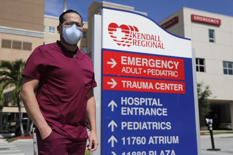 Rublas Ruiz poses for a photograph outside of Kendall Regional Medical Hospital where he works as a nurse in the hospital's intensive care unit.