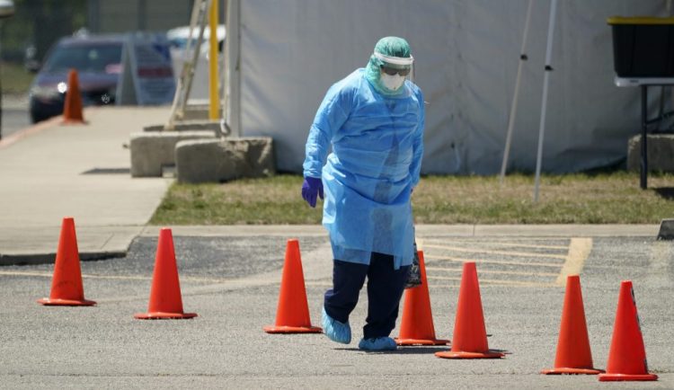 Medical personnel prepare a drive-thru COVID-19 testing site, Friday in San Antonio. Coronavirus testing in Texas has dropped significantly, mirroring nationwide trends, just as schools reopen and football teams charge ahead with plans to play. 
