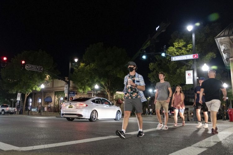 People make their way along The Strip, the University of Alabama's bar scene,  on Aug. 15 in Tuscaloosa, Ala. 

