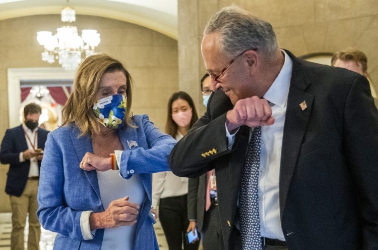 House Speaker Nancy Pelosi of California gives Senate Minority Leader Chuck Schumer of New York an elbow bump as he leaves following a meeting at the Capitol with White House Chief of Staff Mark Meadows and Treasury Secretary Steven Mnuchin on a COVID-19 relief bill   Saturday in Washington. 

