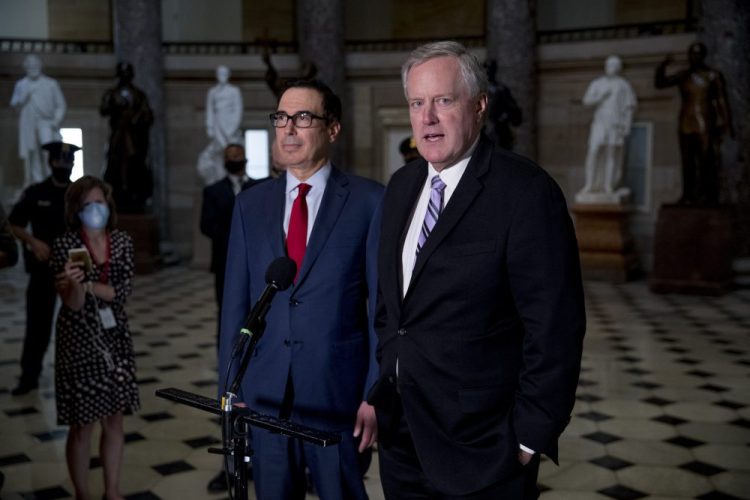 White House Chief of Staff Mark Meadows, right, accompanied by Treasury Secretary Steven Mnuchin, left, speaks to reporters on Aug. 7. Meadows rejected the legislation the House passed late Saturday to provide $25 billion and block operational changes by Postmaster General Louis DeJoy. 