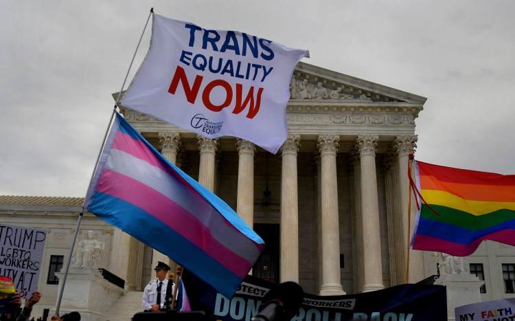 People gather outside  the Supreme Court on Oct. 8, 2019, when the justices heard arguments in the case surrounding transgender protections in the workplace. Monday's federal court ruling  delivers a blow to the Trump administration's ongoing efforts to roll back a series of protections for the LGBTQ community.