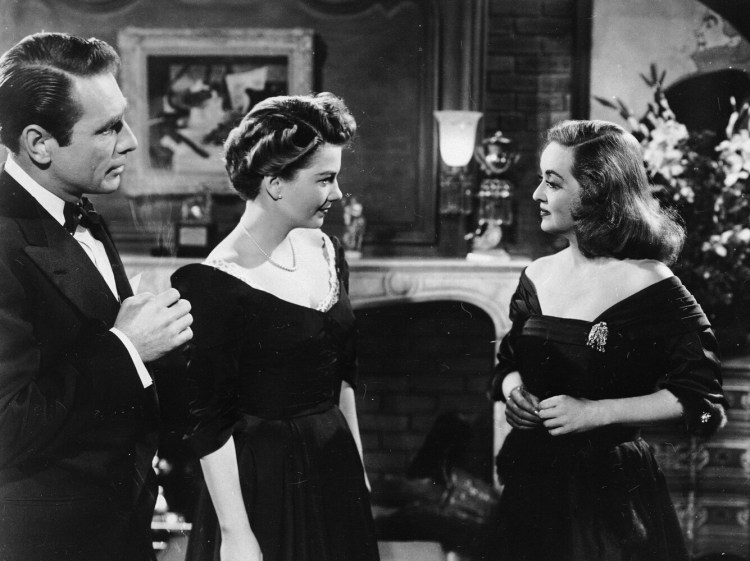 Bette Davis, right, in a scene from the film "All About Eve," with her co-stars Gary Merrrill, left, and Anne Baxter, 1950.  
