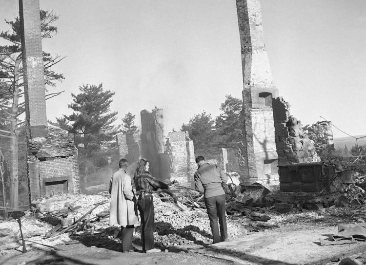 Stark chimneys and brick rubble mark the site of the once-luxurious estate of conductor Walter Damrosch, burned when a forest fire swept Bar Harbor in October of 1947. 


