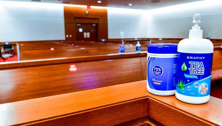 AUGUSTA, ME - SEPTEMBER 11: This Friday September 11, 2020 photo shows wipes and hand sanitizer on the rail of the courtroom 3 jury box in the Capital Judicial Center in Augusta. There are supplies of sanitizer all around the court room. (Staff photo by Joe Phelan/Staff Photographer)