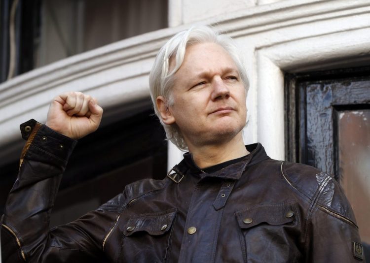 WikiLeaks founder Julian Assange greets supporters in 2017 outside the Ecuadorian embassy in London, where he has been in self-imposed exile since 2012. 

