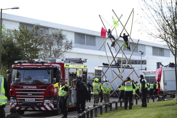 Police and fire officials are at the scene  outside Broxbourne newsprinters as protesters continue to block the road in Broxbourne, Hertfordshire, England, on Saturday.
