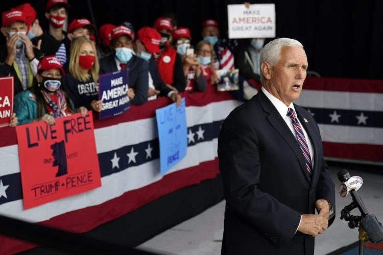 Vice President Mike Pence gives a television interview after a campaign rally on Tuesday at Lanconia Municipal Airport in Gilford, N.H. 