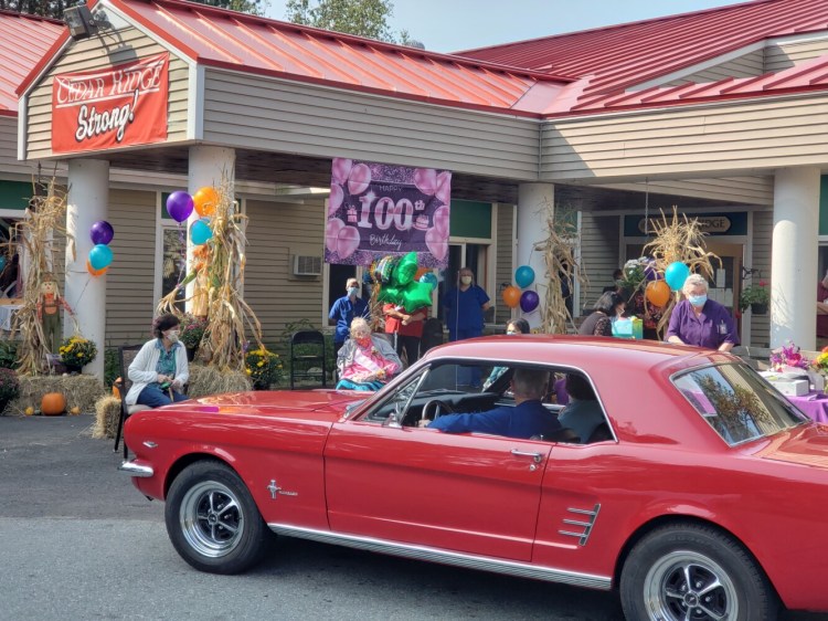 G. Arlene Elias, seated underneath the Happy 100th Birthday banner with balloons tied to her chair was given an outdoor celebration Sept. 16 with a parade of antique automobiles at Cedar Ridge Center in Skowhegan.